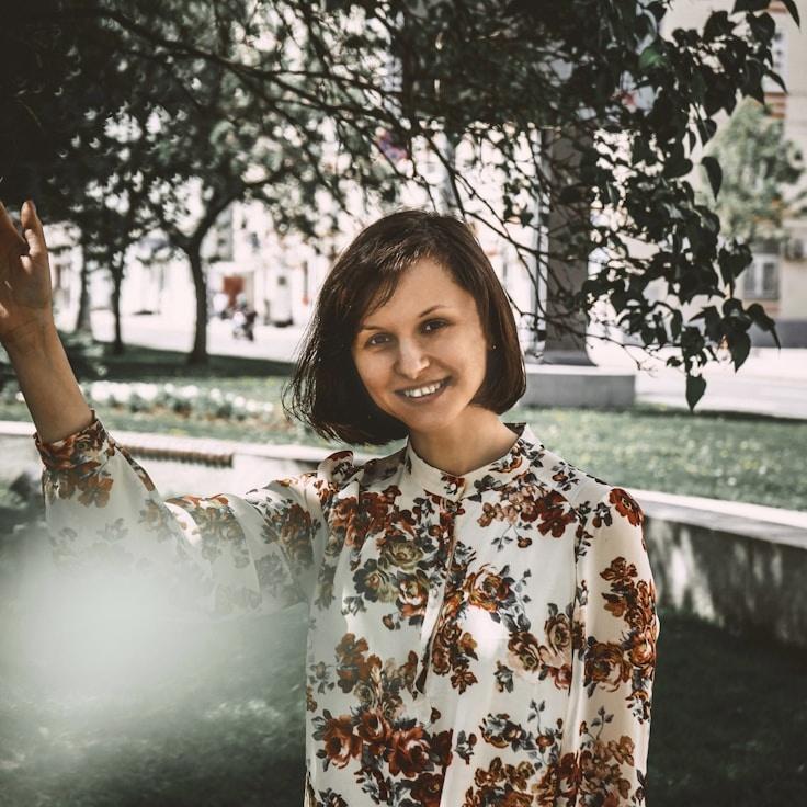 Avery Singh, Lead Design Curator at GroveLaneMarket, reviewing corporate floral arrangements